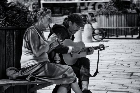 Greyscale Photography of Man and Woman Playing Musical Instruments