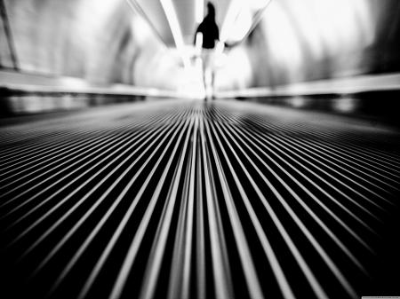 Greyscale Photography of Man Walking on Tunnel