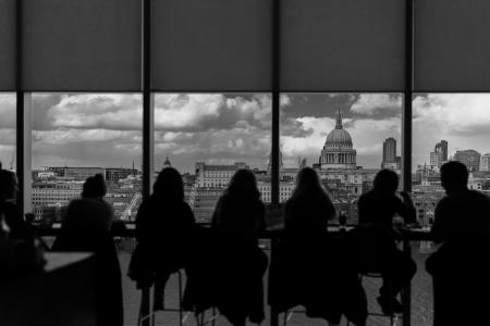 Greyscale Photography of Silhouette of People Inside Building