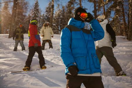 Group of People in Bubble Jackets Skiing in Mountain