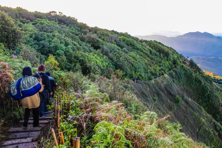 Group of People Walking Near Cliff