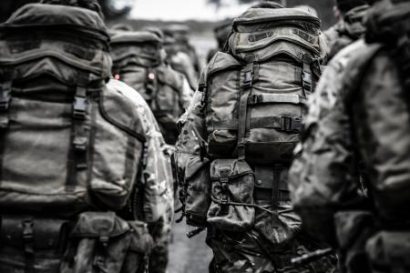 Group of People With Camouflage Backpack