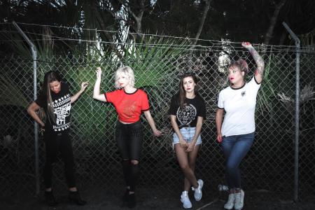 Group of Women Beside Stainless Steel Cyclone Fence