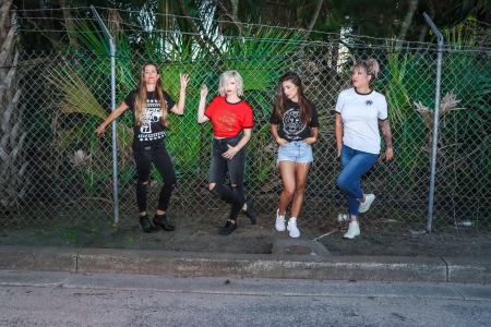 Group of Women Standing in Front Metal Fence