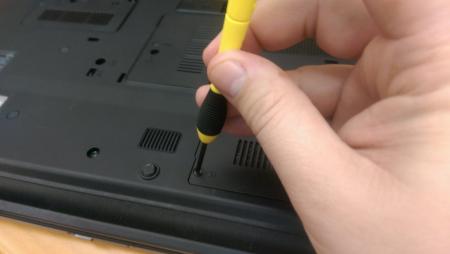 Hand holding a laptop screwdriver