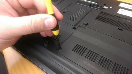 Hand holding a laptop screwdriver
