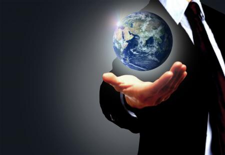 Hand of a businessman holding Earth globe - Globalization concept