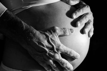 Hands on belly of a pregnant woman