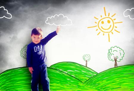 Happy child drawing a sunny landscape