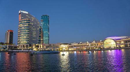 High-rise Building Near Body of Water during Night Time