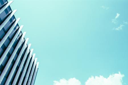 High Rise Building Under White Clouds and Blue Sky