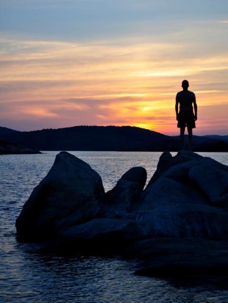 Hiker on the Rocks by the Lake