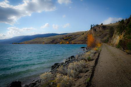 Hills Beside Body of Water during Day Time