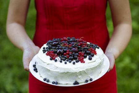 Holding a fresh berry cake