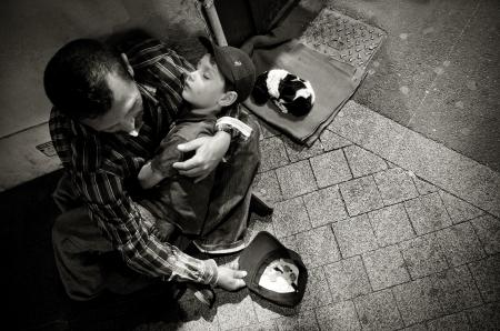 Homeless man with child and puppy