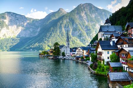 Houses Beside Body of Water and Mountains at Daytime