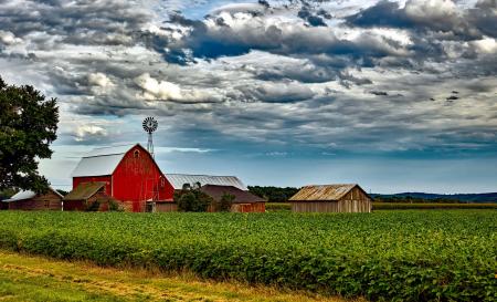 Houses in Farm Against Cloudy Sky
