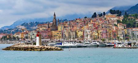 Houses Near With Sea With Sailboats and Lighthouse during Daytime