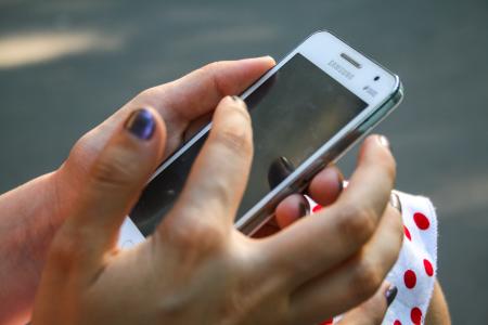 Human Hand Holding White Samsung Duos Android Smartphone