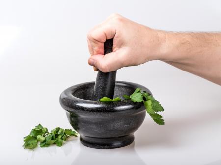 Human Holding Black Ceramic Pestle