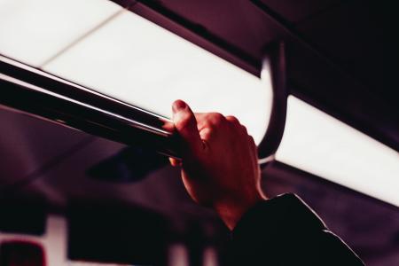 Human's Hand Holding on Silver Handle Bar Photography