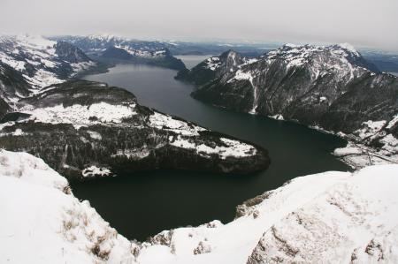 Islands With Snow Near Body of Water