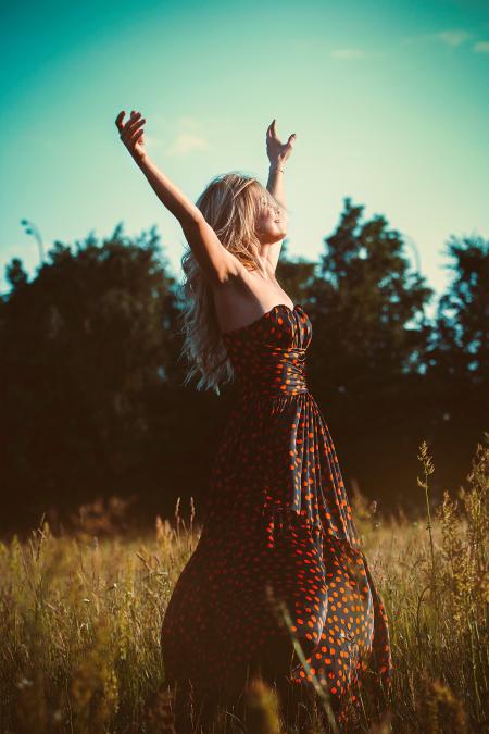 Lady in Dress Posing for Photo in Strapless Black Red Dotted Maxi Dress in Field