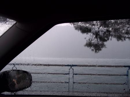 Lake from a wet window of a car