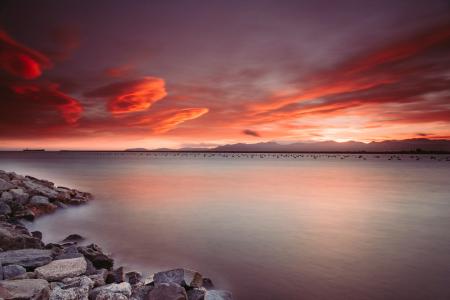 Landscape Photography of Rocks Near Body of Water during Sunset