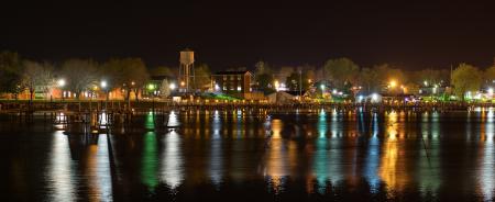 Landscape Photography of Town Near Body of Water during Nightime