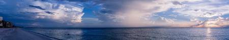 Large Body of Water Under Cloudy Sky