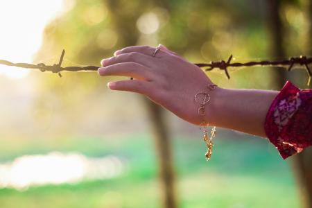 Left Persons Hand Holding a Bulb Wire