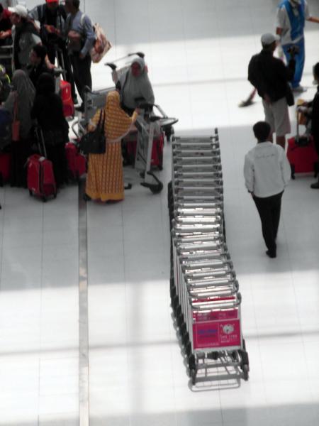 Line of Airport Luggage Trolleys