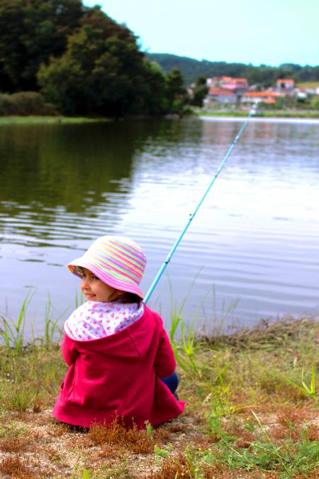 Little girl fishing and smiling