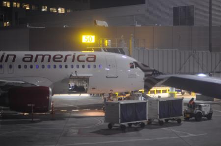 Loading baggage on plane at night