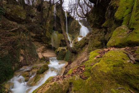 Long Exposure Photo of Stream Falling in Between Rocky Mountain