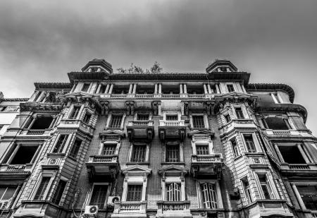 Low-angle and Grayscale Photo of Concrete Building