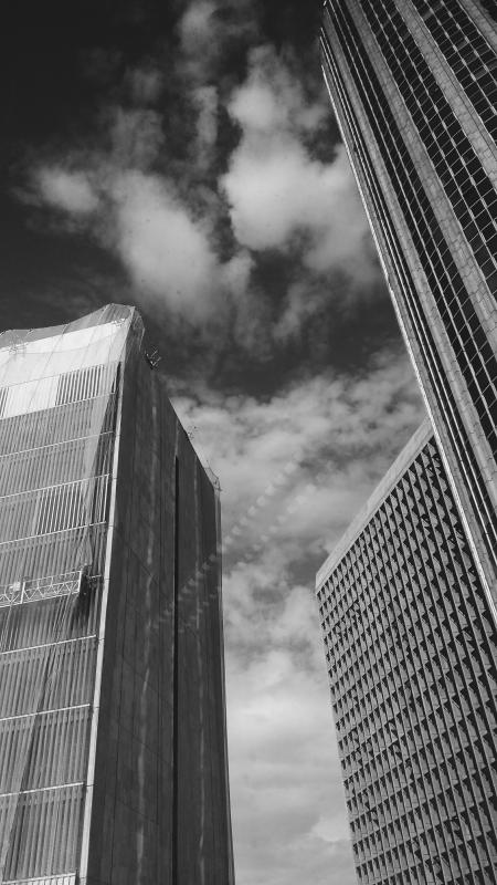 Low Angle Grayscale Photography of Buildings and Clouds