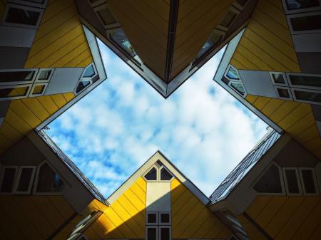 Low Angle Photo of Yellow Wall Paint Building Under White Sky at Daytime