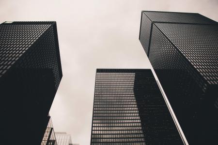 Low Angle Photography of Black High Rise Building Under Nimbus Clouds Background