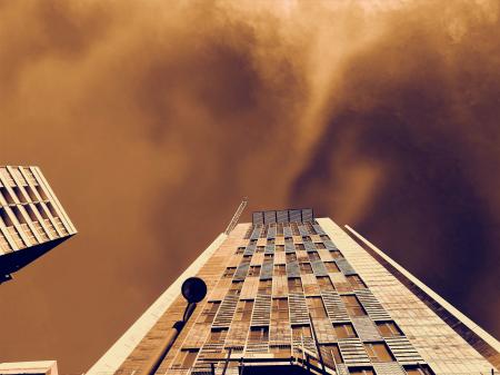 Low-angle Photography of Brown Concrete Building Under Brown Clouds