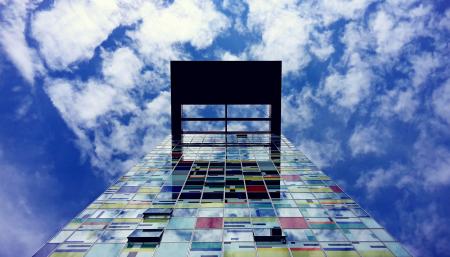 Low Angle Photography of Glass Building Under White Cloud and Blue Sky during Daytime