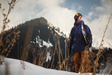 Low Angle Photography of Man Wearing Blue Jacket Carrying Snow Board