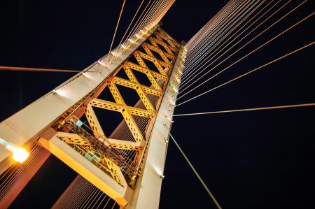 Low Angle Photography of White and Yellow Suspension Bridge at Nighttime