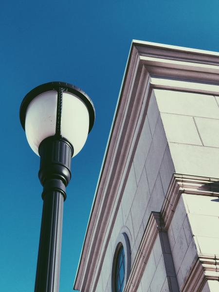 Low Angle View of Gray Concrete Building Beside Black Post