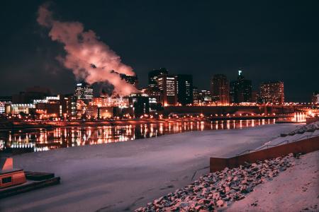 Low Light Photo of Lighted Buildings in Front of Body of Water