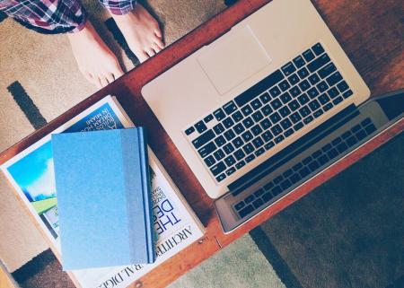 Macbook Air Beside 2 Books on Table