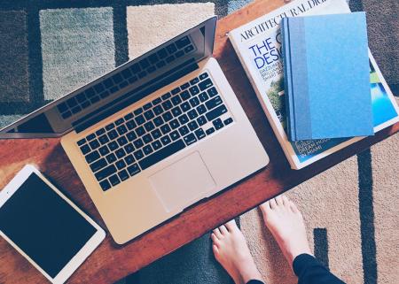 Macbook Pro on Brown Wooden Desk