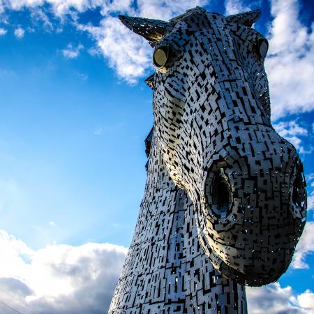 Macro Photography of Mechanical Horse Face Under White and Blue Cloudy Sky