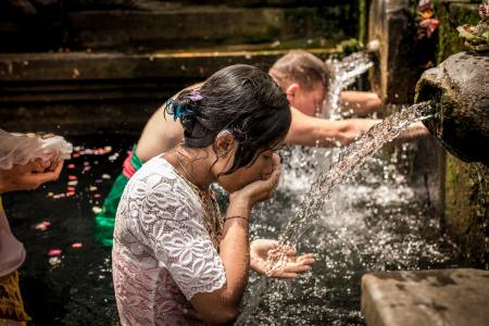 Man and Woman Bathing on Running Water